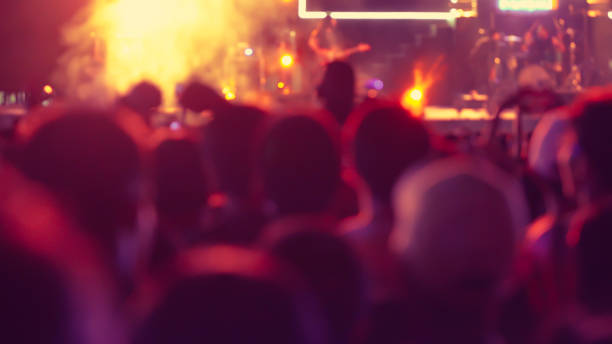 istock abstract colorful background audience in public concert. 1124984448