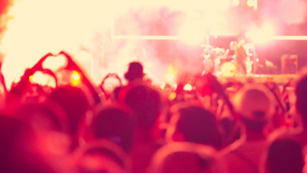 istock abstract colorful background audience in public concert. 1124984450