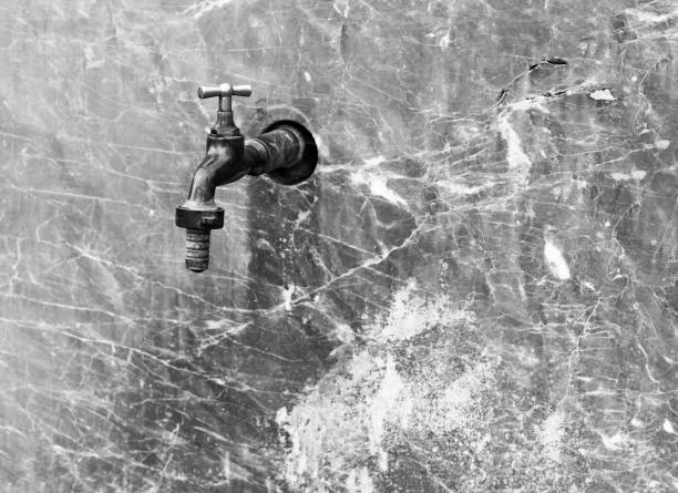 istock Water faucet on a marble wall 1124984733