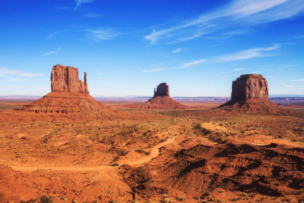 Monument Valley on the border between Arizona and Utah, USA Dirt road leading through Monument Valley on the border between Arizona and Utah, USA. mesa arizona stock pictures, royalty-free photos & images