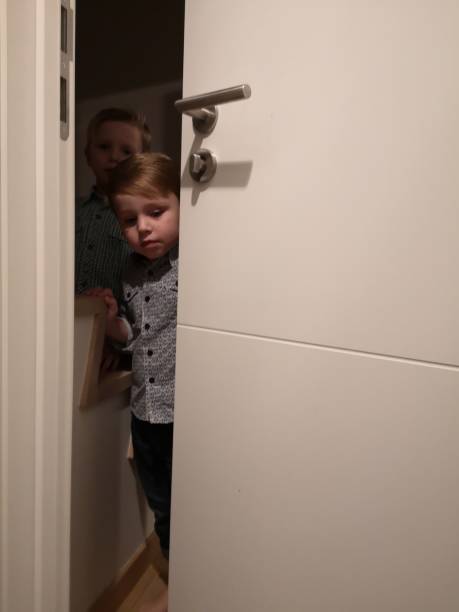 toddlers mischief, hiding behind door