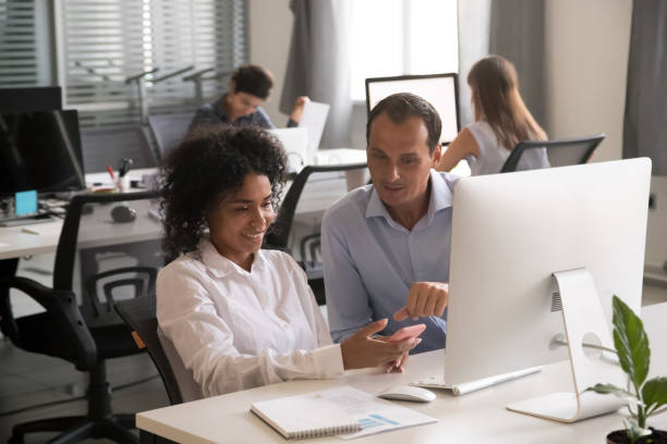 istock Multiracial colleagues communicate sitting in the office 1124997276
