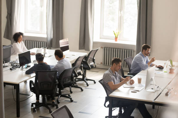 istock Above view office and workers sitting at desk 1124997363
