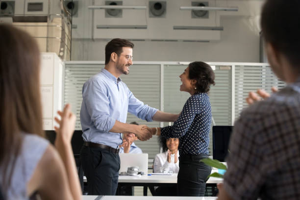 istock Happy young business people handshaking in office 1124997365