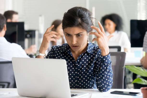 istock Upset female office worker reading unpleasant message 1124997379