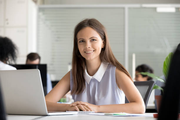 istock Headshot young employee sitting in office looking at camera 1124997417