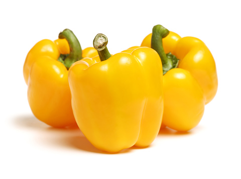 Green, yellow and red fresh bell pepper or capsicum isolated on white background
