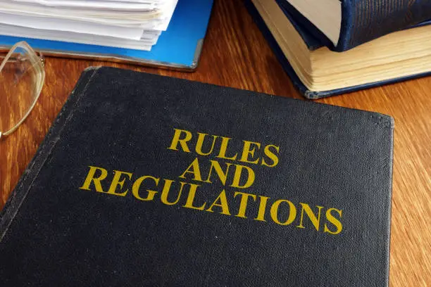 Photo of Rules and regulations book on the desk.
