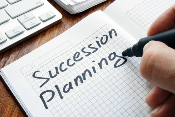 Man is writing succession planning in the book. Man is writing succession planning in the book. continuity photos stock pictures, royalty-free photos & images