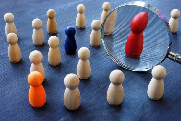 istock Talent Sourcing concept. Magnifying glass and wooden figures. 1125004744