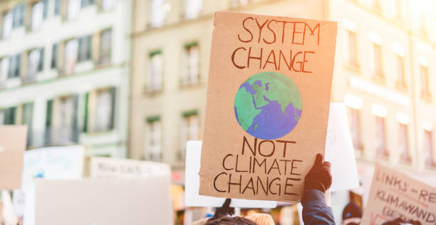 groep van demonstranten onderweg, jongeren strijd voor verandering van het klimaat - globale opwarming van de aarde en milieu concept - focus op banner - climate stockfoto's en -beelden
