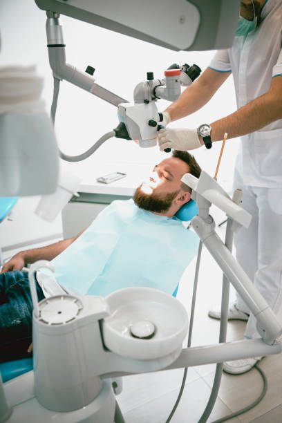 istock Male Dentist Preparing To Perform Surgery On Patient 1125009617