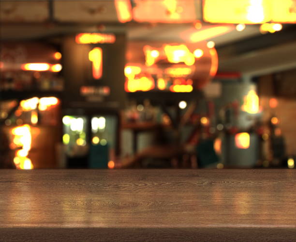 istock Blur bokeh background with empty wooden table top in night cafe 1125010800