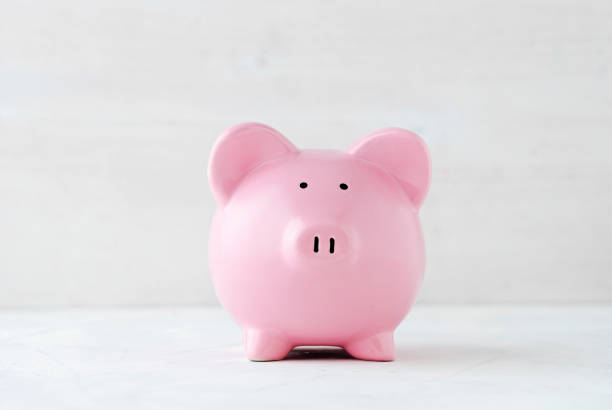 istock Pink piggy bank over a light off white background 1125011324