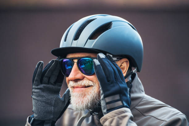istock Close-up of active senior man standing outdoors, putting on sunglasses. 1125012812