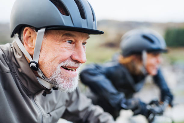 istock Active senior couple with electrobikes cycling outdoors on a road in nature. 1125012923