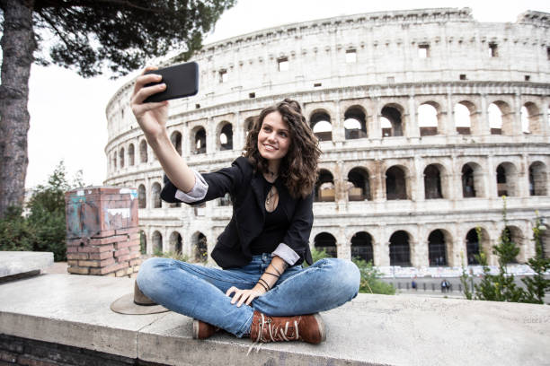 istock Beautiful woman having fun in front of Coliseum 1125015357