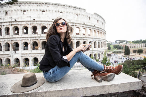 istock Beautiful woman having fun in front of Coliseum 1125015363