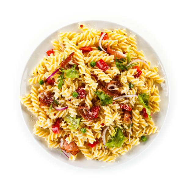 pasta with ham smoked and vegetables on white background - pasta directly above fusilli food imagens e fotografias de stock