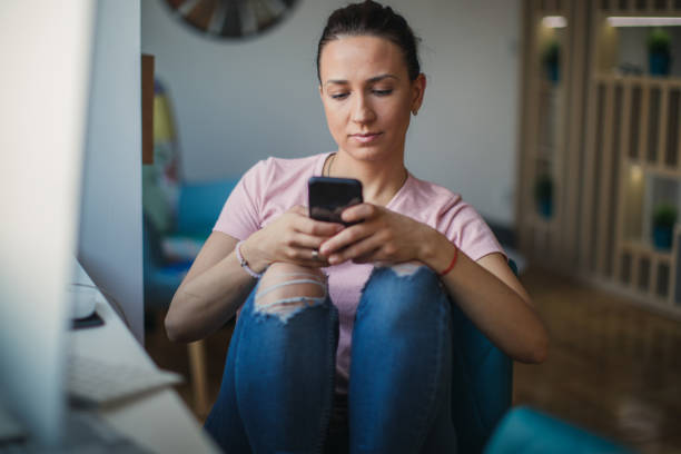 istock Beautiful lady in home office using smart phone 1125019880