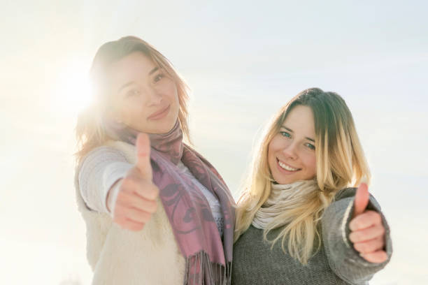 istock Two girlfriends show thumbs up 1125019975