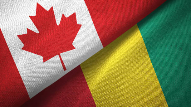 istock Guinea and Canada two flags together textile cloth, fabric texture 1125020432