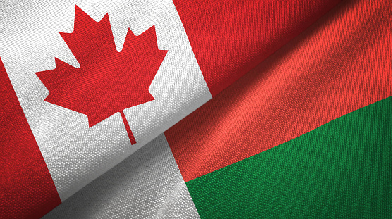 Madagascar and Canada flags together textile cloth, fabric texture
