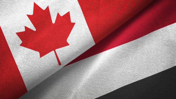 istock Yemen and Canada two flags together textile cloth, fabric texture 1125022371