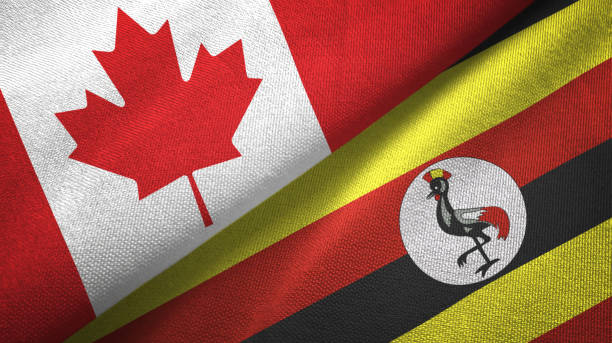 istock Uganda and Canada two flags together textile cloth, fabric texture 1125022376