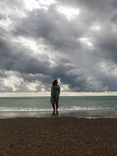 istock Woman walking at the seaside 1125028701