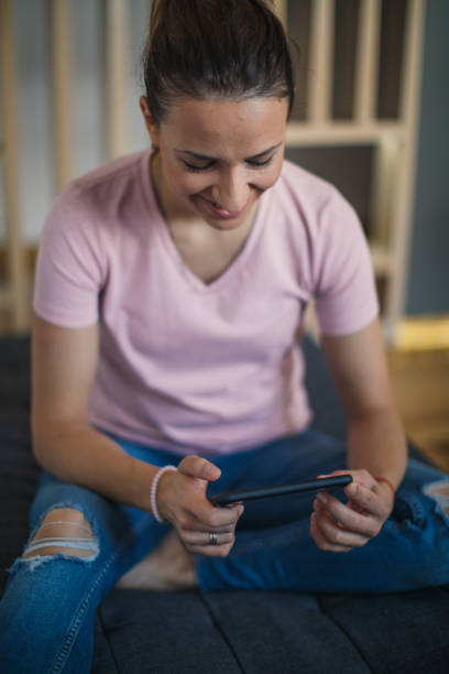 istock Woman using smart phone at home 1125030250