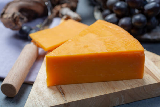 istock Piece of hard orange Cheddar cheese close up 1125035916