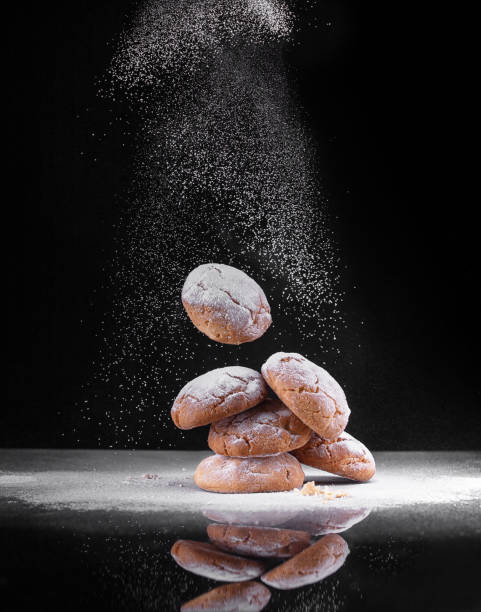 cookies with powdered sugar on a black background stock photo