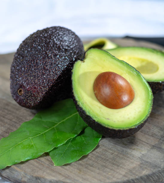 istock Two ripe raw hass avocados close up 1125038800