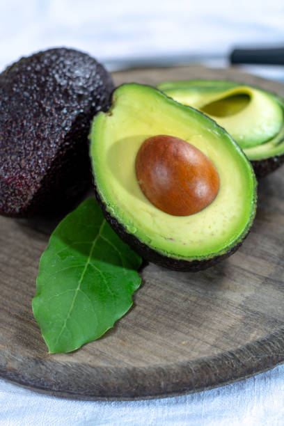 istock Two ripe raw hass avocados close up 1125038815