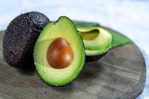 istock Two ripe raw hass avocados close up 1125038818