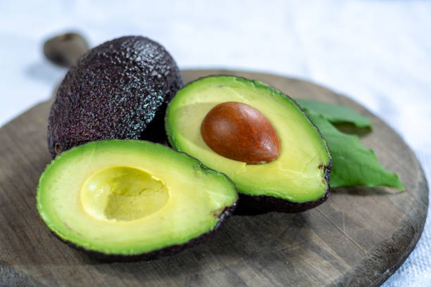 istock Two ripe raw hass avocados close up 1125038826