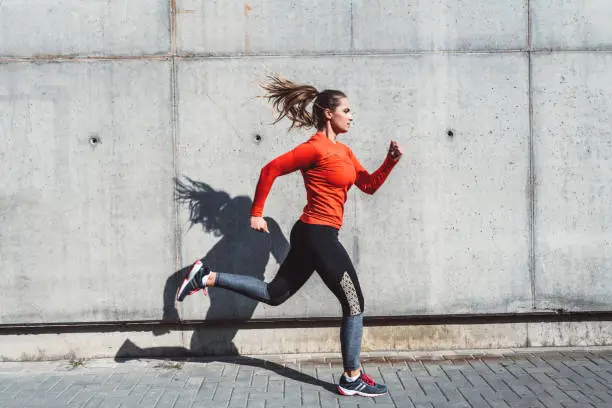 Photo of Woman running outdoors in the city