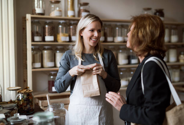 istock A female shop assistant serving a senior customer in a zero-waste shop. 1125041424