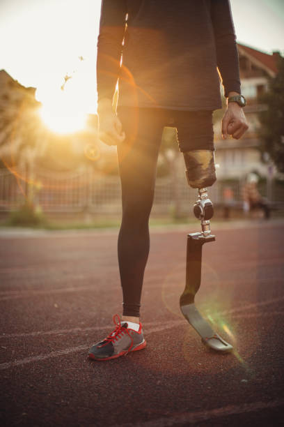istock Sprinter man with prosthetic leg on race track 1125043811