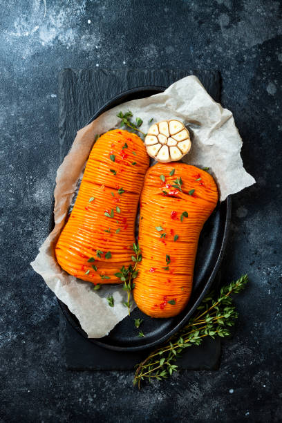 istock Harissa roasted hasselback butternut squash pumpkin with thyme and garlic. Thanksgiving dinner recipe. Vegan healthy seasonal fall or autumn food 1125045031