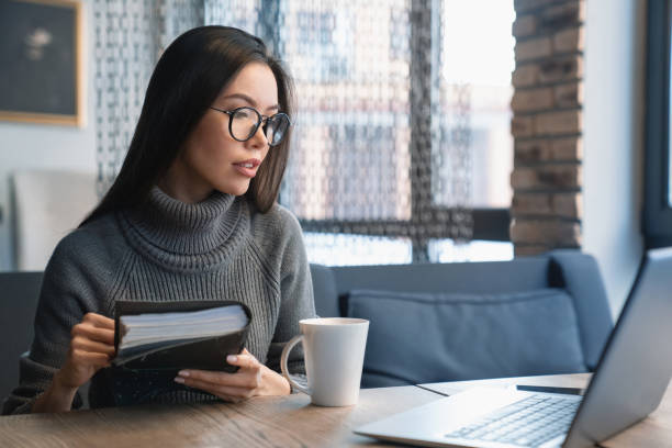 istock Businesswoman is looking at laptop screen while sitting at her workplace 1125045512