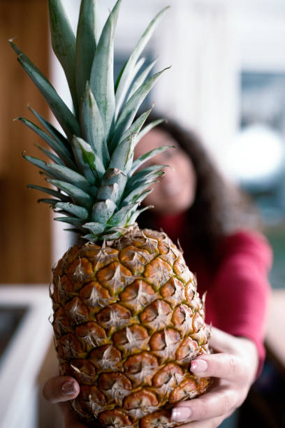 Beautiful woman holding pineapple