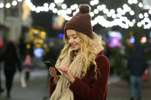 istock Young woman using smart phone at night in city 1125049437