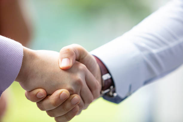 istock Close-up of coworkers shaking hands 1125054570
