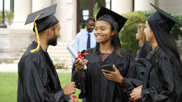 istock Excited college grad talks with friends 1125055204