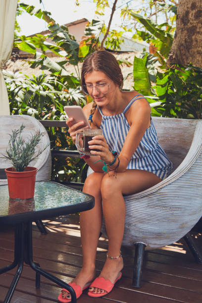 istock Cute girl with eyeglasses using cellphone  on a terrace. 1125056879