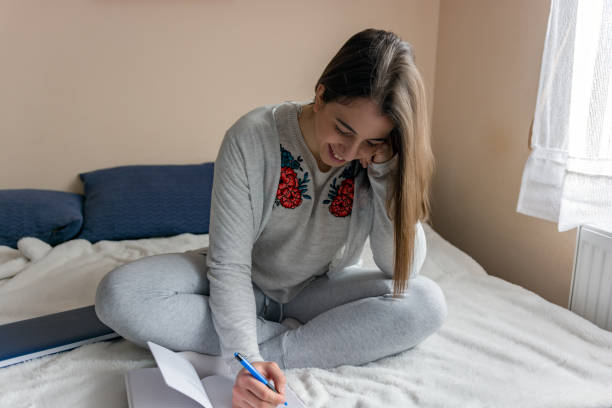 istock Teenage girl doing homework 1125057077