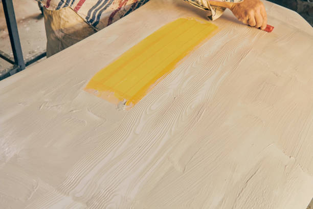 istock Artist using paint brush for making artificial wood texture. 1125057628