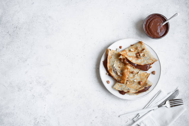 Crepes with chocolate and hazelnuts stock photo